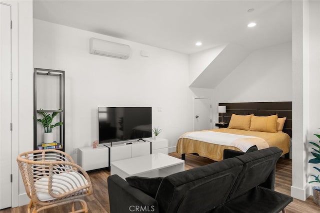 bedroom featuring wood-type flooring and a wall mounted air conditioner