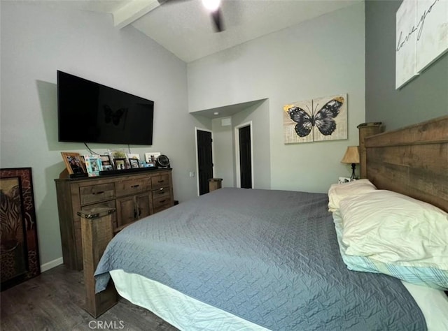 bedroom with ceiling fan, hardwood / wood-style flooring, and vaulted ceiling with beams