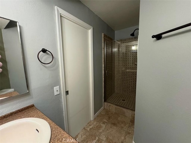 bathroom featuring vanity and tiled shower