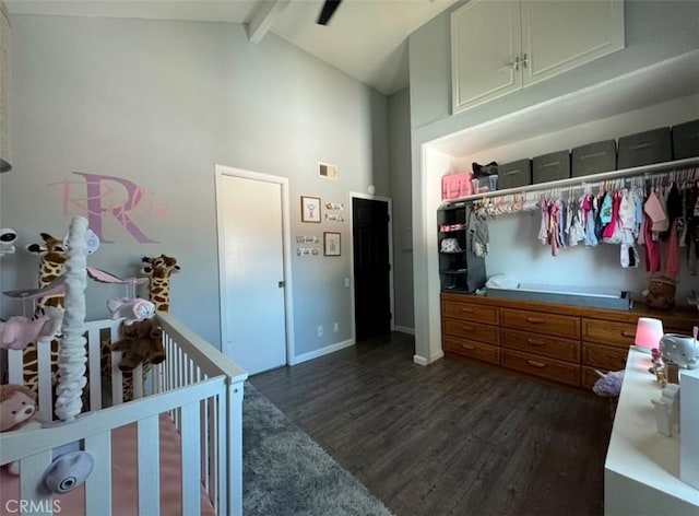 bedroom featuring a nursery area, a closet, dark hardwood / wood-style flooring, high vaulted ceiling, and beam ceiling