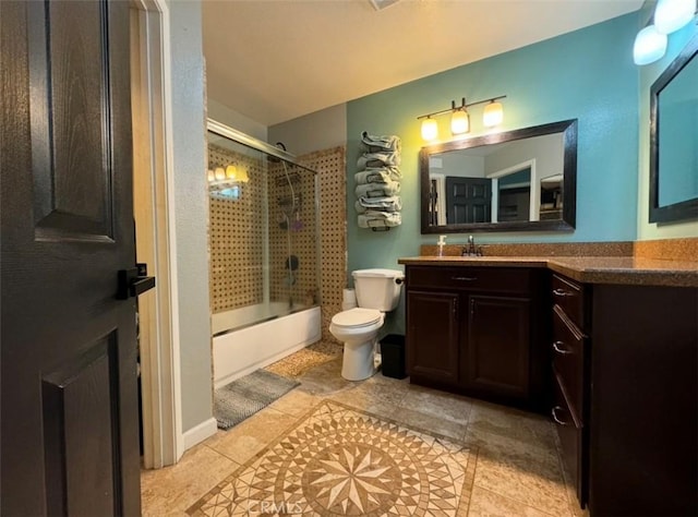 full bathroom with combined bath / shower with glass door, vanity, and toilet