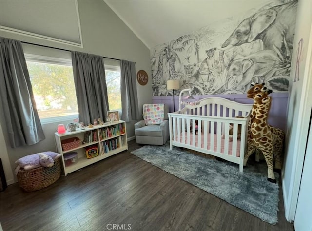 bedroom with lofted ceiling, dark hardwood / wood-style flooring, and a crib