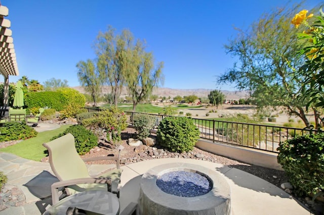 view of patio / terrace featuring a mountain view and an outdoor fire pit