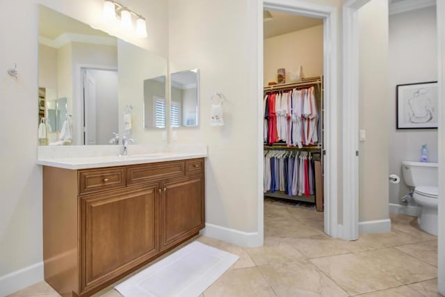 bathroom with vanity, toilet, and tile patterned flooring