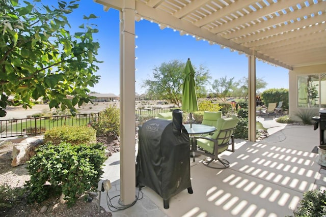 view of patio featuring a grill and a pergola