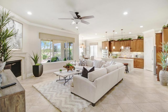 tiled living room featuring ornamental molding and ceiling fan