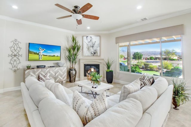 living room featuring light tile patterned floors, crown molding, and ceiling fan