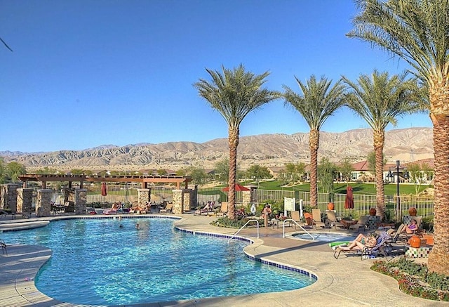 view of swimming pool featuring a mountain view and a patio area