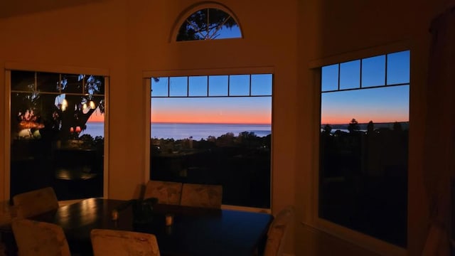 sunroom / solarium with a water view