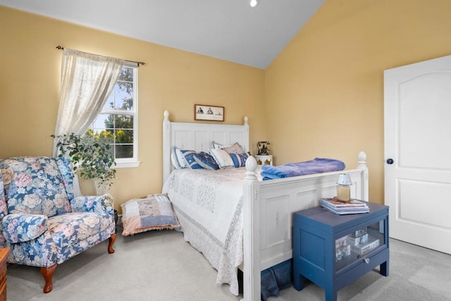 bedroom with lofted ceiling and light carpet