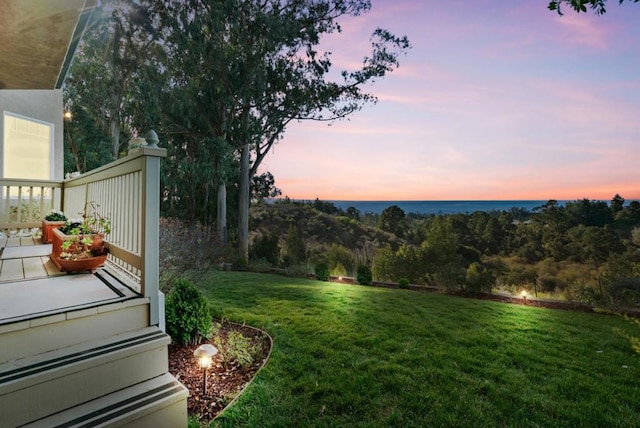 yard at dusk with a water view