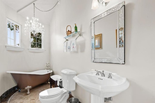 bathroom featuring vaulted ceiling, sink, toilet, a bath, and an inviting chandelier