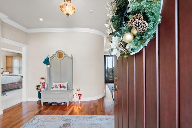 foyer featuring crown molding and wood-type flooring