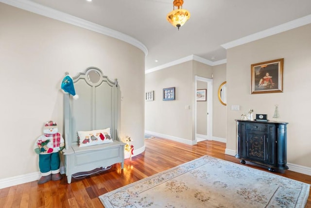 entryway with wood-type flooring and ornamental molding