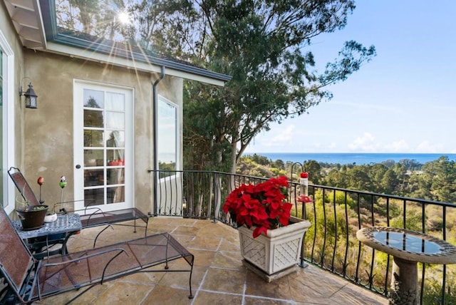 balcony featuring a water view