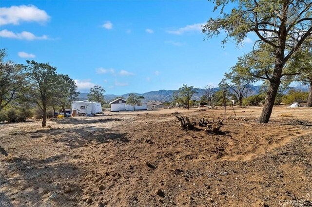 view of yard featuring a rural view and a mountain view