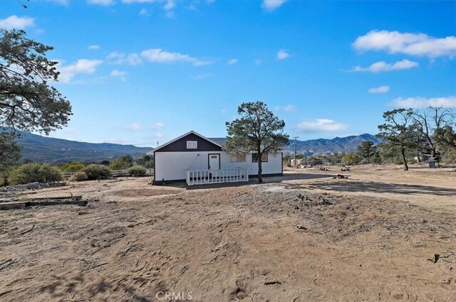 back of property featuring a mountain view