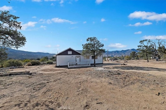 rear view of property with a mountain view