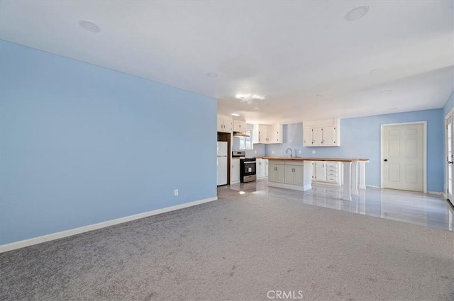 unfurnished living room featuring sink