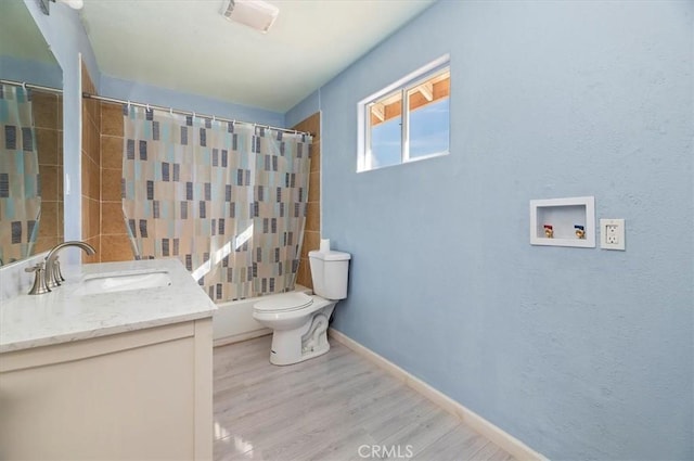 full bathroom featuring hardwood / wood-style floors, shower / bath combo with shower curtain, vanity, and toilet