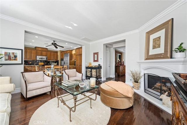 living room featuring ceiling fan, dark hardwood / wood-style floors, and ornamental molding