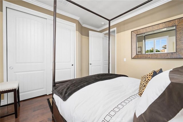 bedroom with a closet, ornamental molding, and dark hardwood / wood-style flooring