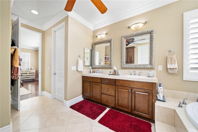 bathroom with tiled bath, tile patterned flooring, crown molding, and vanity