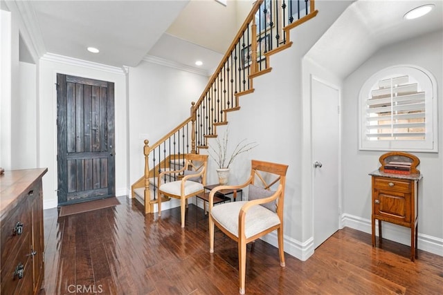 foyer featuring dark wood-type flooring and ornamental molding