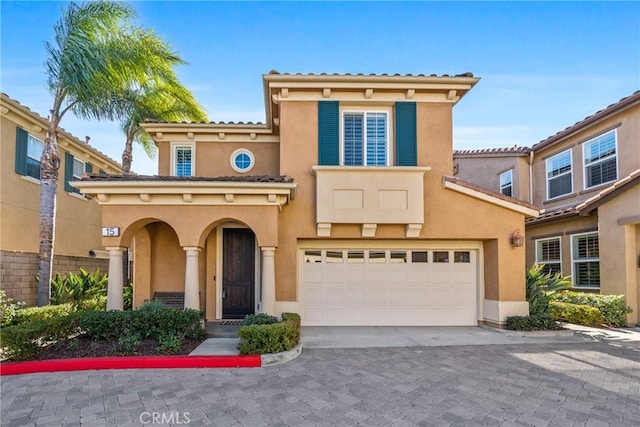 mediterranean / spanish-style home featuring a garage