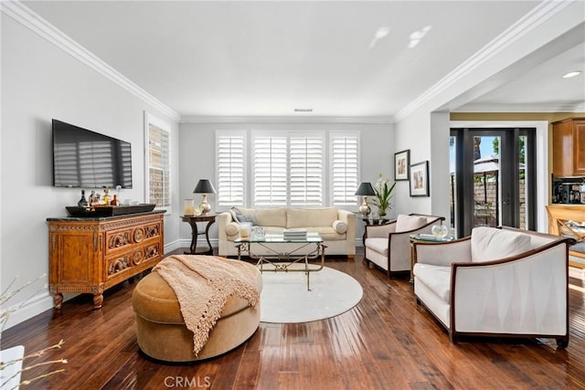 living room featuring dark hardwood / wood-style floors, crown molding, and a healthy amount of sunlight