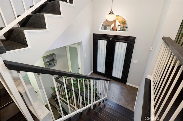 entrance foyer featuring a high ceiling, dark hardwood / wood-style floors, and french doors