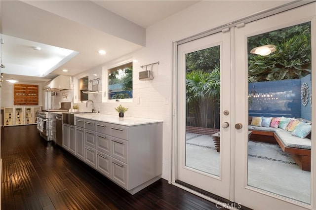 entryway with sink, dark hardwood / wood-style floors, and french doors