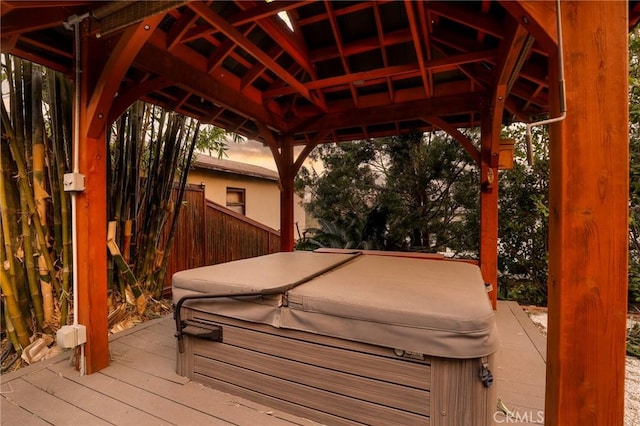 wooden deck with a gazebo and a hot tub