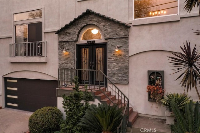 doorway to property with a garage