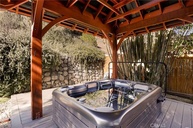 wooden deck featuring a hot tub