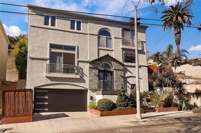 view of front facade with a garage and a balcony