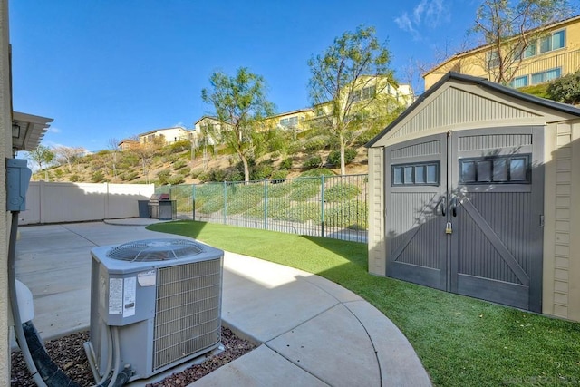 view of patio / terrace with a shed and central AC