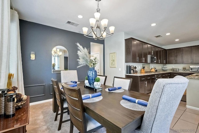 dining area with an inviting chandelier and light tile patterned floors