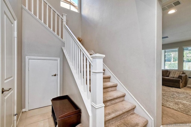 stairs featuring tile patterned flooring