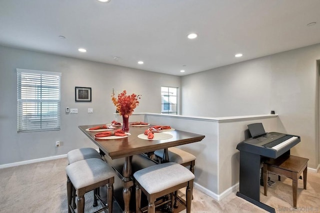 carpeted dining room with a wealth of natural light