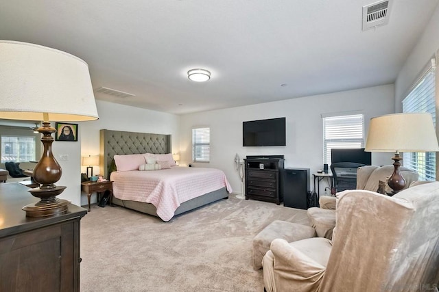 bedroom featuring light carpet