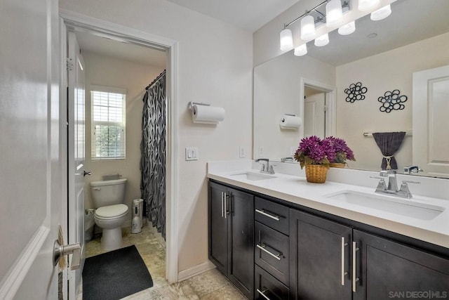 bathroom featuring toilet and vanity