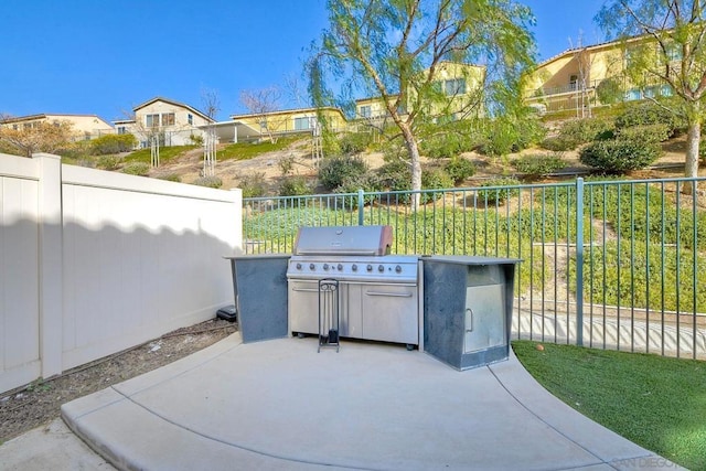 view of patio with an outdoor kitchen and a grill