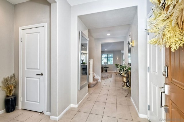 corridor featuring light tile patterned floors