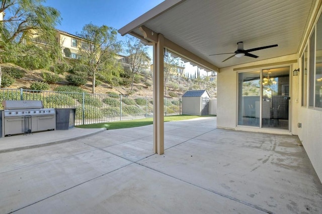 view of patio featuring ceiling fan, a storage shed, and area for grilling