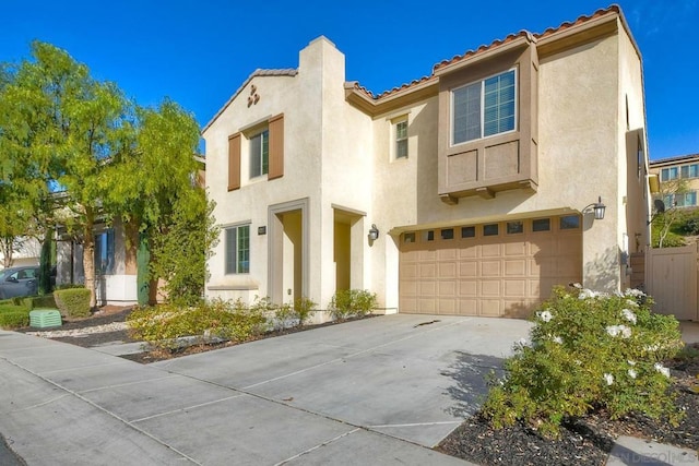 mediterranean / spanish-style home with a garage