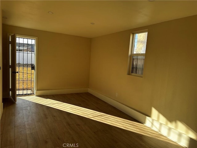 unfurnished room featuring dark hardwood / wood-style flooring