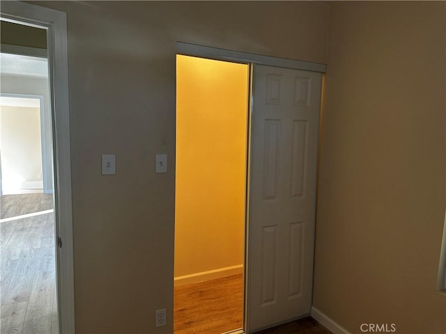 unfurnished bedroom featuring hardwood / wood-style floors and a closet