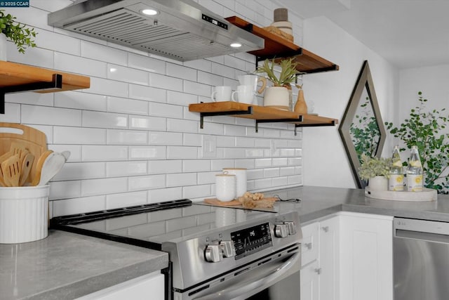 kitchen featuring ventilation hood, backsplash, stainless steel appliances, and white cabinetry