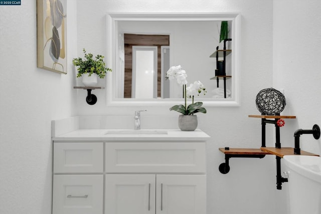 bathroom featuring toilet and vanity